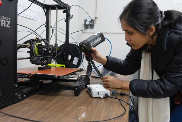 Researcher using a thermal camera for a research study